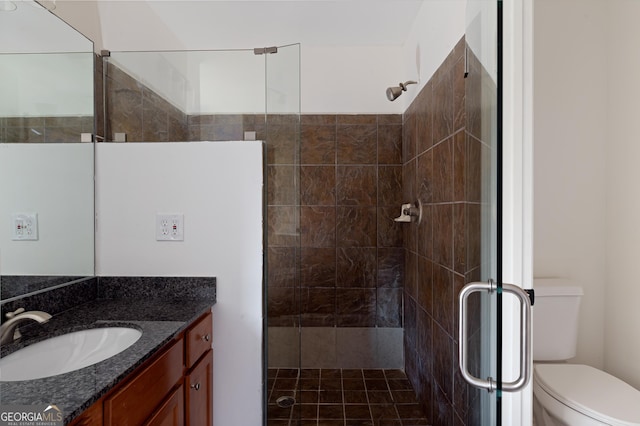 bathroom featuring vanity, toilet, and walk in shower