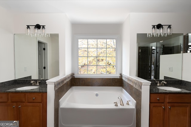 bathroom featuring shower with separate bathtub and vanity