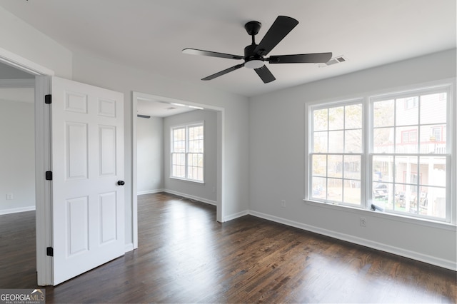 empty room with dark hardwood / wood-style floors and ceiling fan