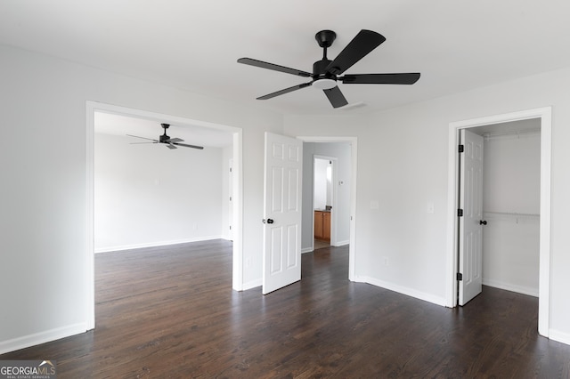 unfurnished room with ceiling fan and dark hardwood / wood-style flooring