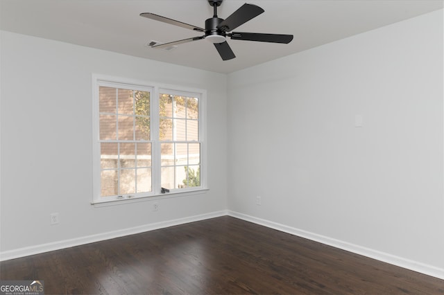 empty room with ceiling fan and dark hardwood / wood-style floors