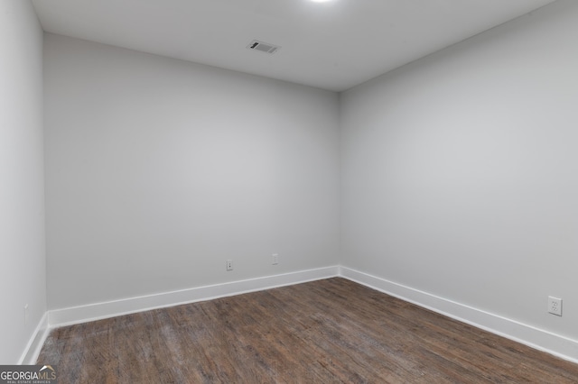 empty room with dark hardwood / wood-style floors