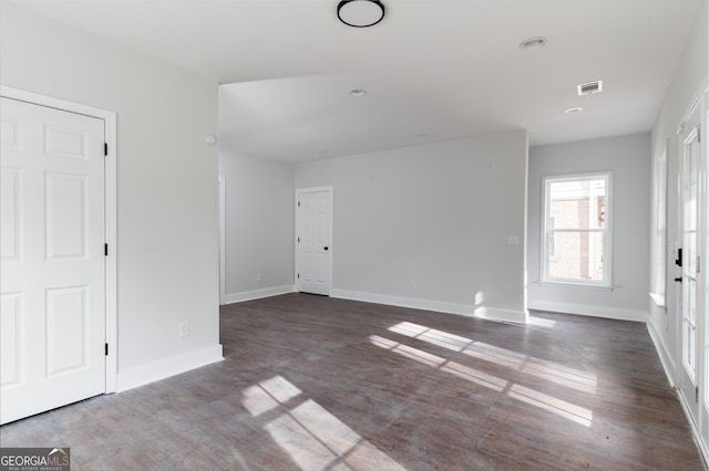 unfurnished room featuring dark hardwood / wood-style flooring