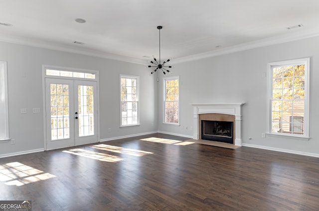 unfurnished living room featuring a healthy amount of sunlight, dark hardwood / wood-style flooring, and crown molding