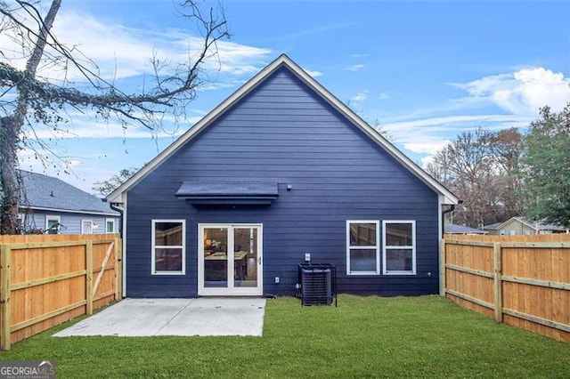 rear view of property featuring cooling unit, a patio, and a lawn