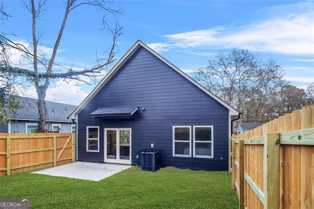 back of house featuring a yard, central air condition unit, and a patio area