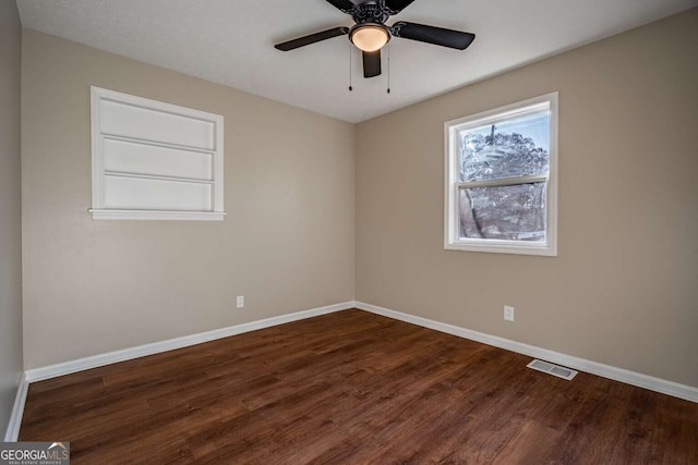 unfurnished room with ceiling fan and dark hardwood / wood-style flooring