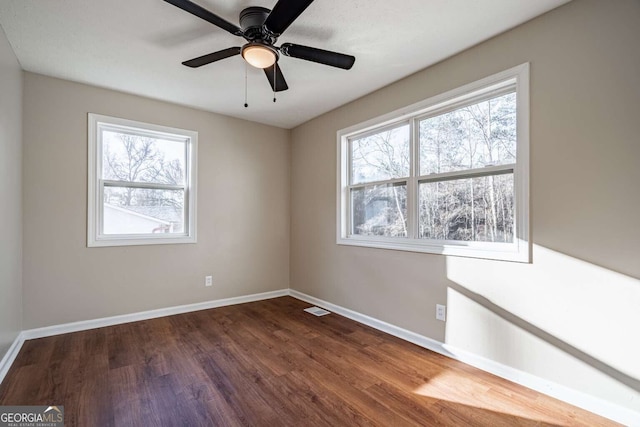 empty room with hardwood / wood-style flooring and ceiling fan