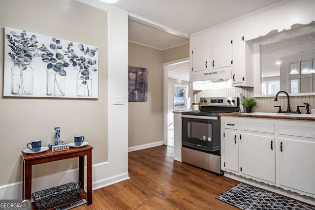 kitchen with wood-type flooring, sink, stainless steel range with electric cooktop, and white cabinets