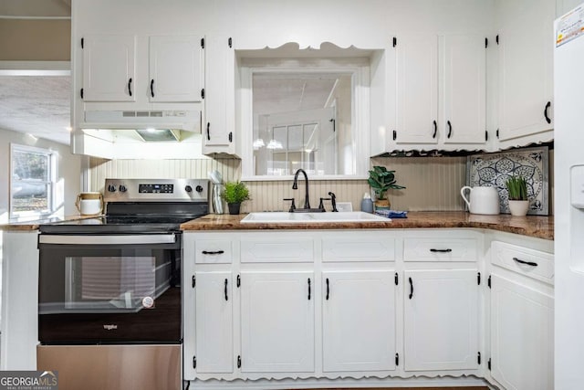 kitchen with sink, stainless steel electric range, and white cabinets