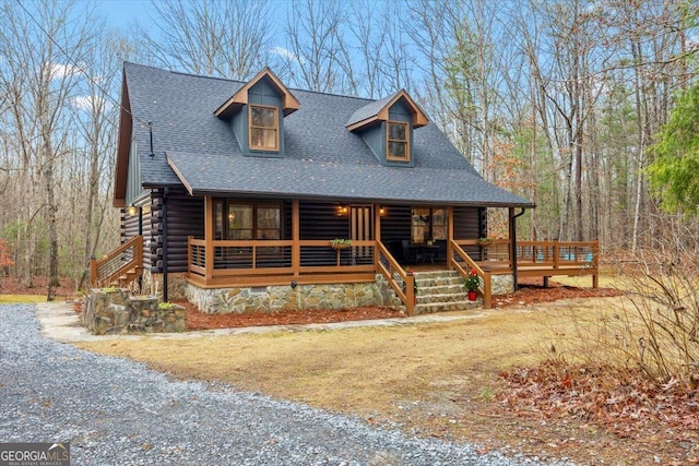 log home featuring a porch