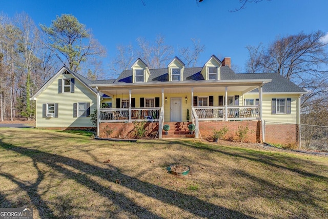 cape cod home featuring a front lawn and covered porch