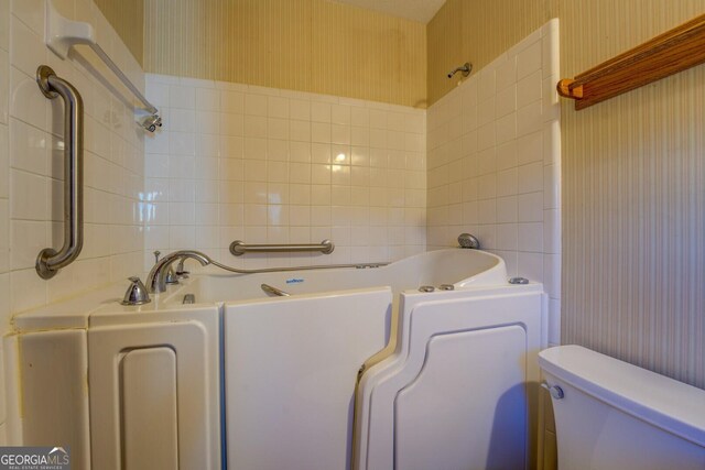 bathroom featuring toilet and a bathing tub