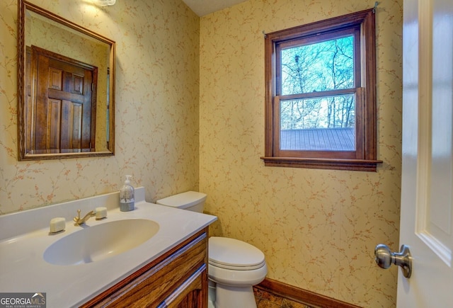 bathroom featuring vanity and toilet