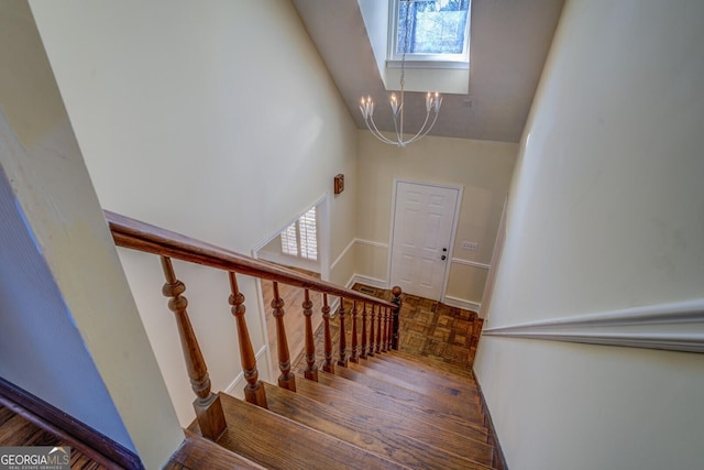 stairway with a chandelier