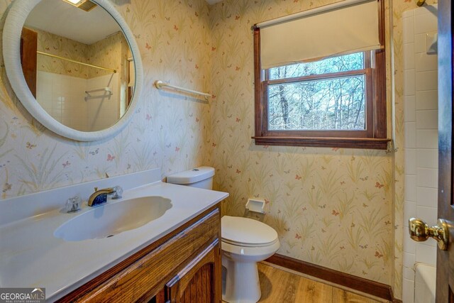 full bathroom with shower / tub combination, vanity, wood-type flooring, and toilet