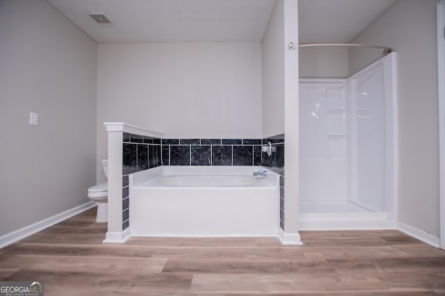 bathroom featuring hardwood / wood-style floors, independent shower and bath, and toilet