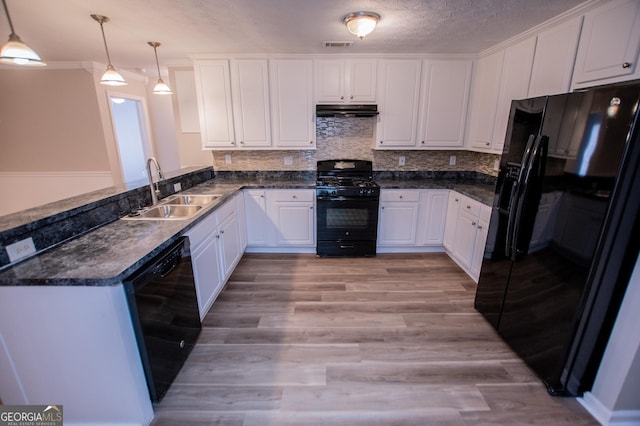 kitchen featuring black appliances, sink, decorative light fixtures, light hardwood / wood-style floors, and white cabinetry