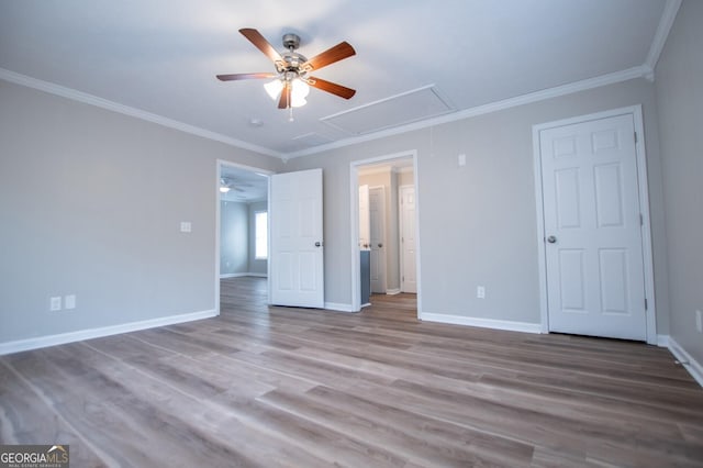 unfurnished bedroom featuring ceiling fan, crown molding, and light hardwood / wood-style flooring