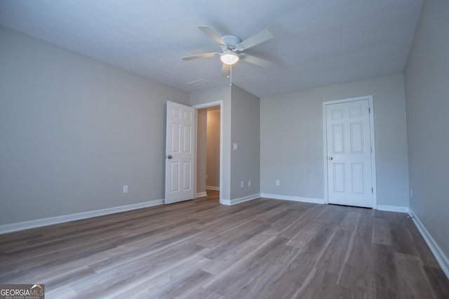 unfurnished bedroom featuring hardwood / wood-style flooring and ceiling fan