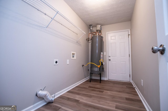 laundry room with washer hookup, gas water heater, electric dryer hookup, dark hardwood / wood-style floors, and a textured ceiling