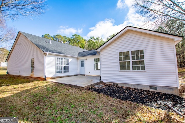 rear view of property featuring a lawn and a patio area