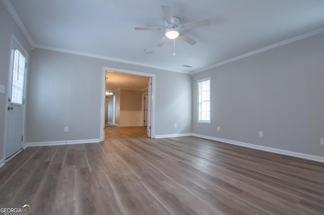 unfurnished room with dark hardwood / wood-style floors, crown molding, and ceiling fan with notable chandelier