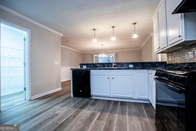 kitchen featuring exhaust hood, white cabinetry, hanging light fixtures, and black appliances