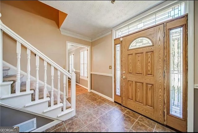 entrance foyer featuring crown molding and a textured ceiling