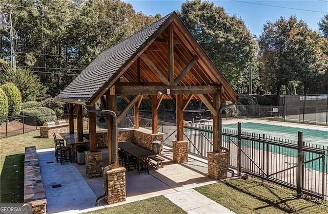 view of property's community with a gazebo, a patio area, an outdoor bar, and a pool