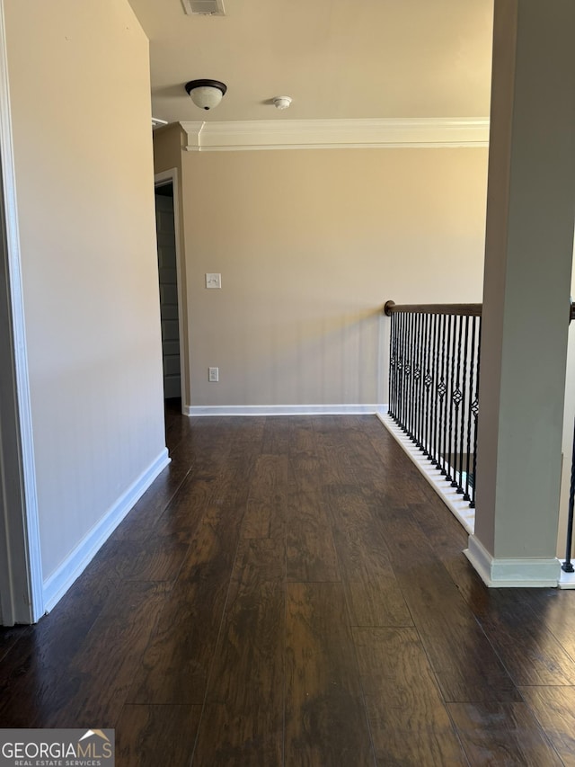 hallway featuring crown molding and dark hardwood / wood-style flooring