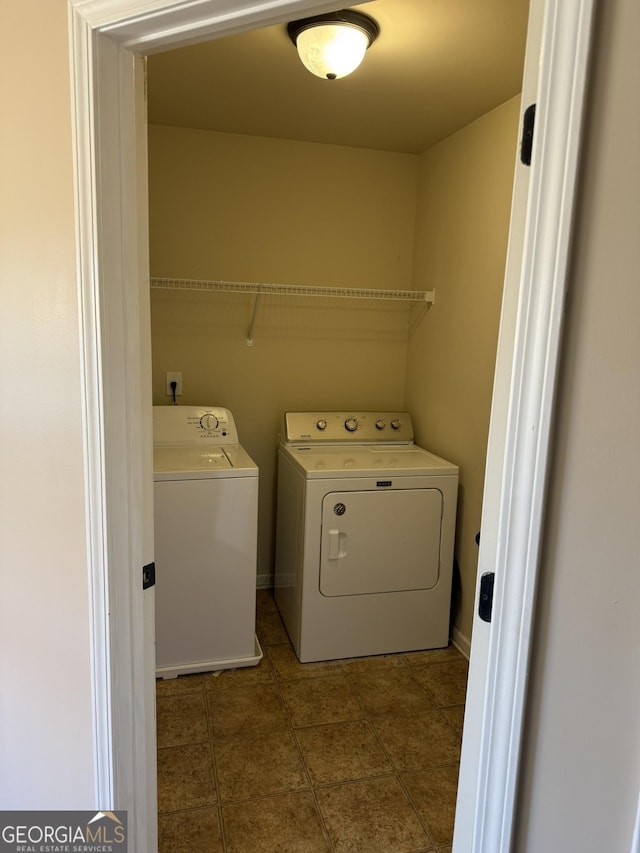 clothes washing area featuring washer and dryer