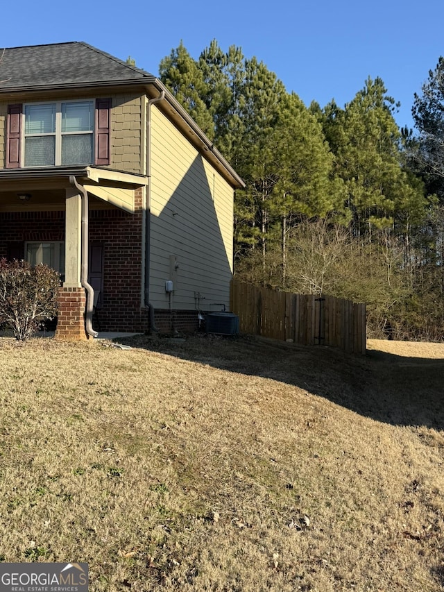 view of side of home with central AC unit