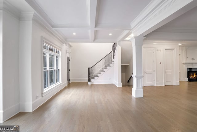 entryway with crown molding, hardwood / wood-style floors, beam ceiling, coffered ceiling, and ornate columns