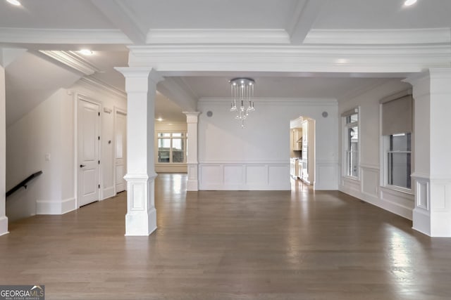 unfurnished room featuring ornate columns and dark hardwood / wood-style flooring