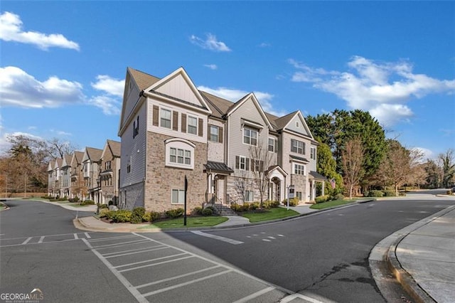 view of road with sidewalks, a residential view, and curbs