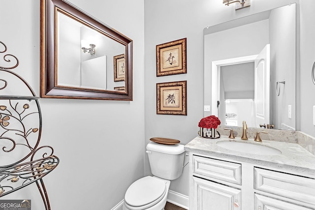 bathroom with toilet and vanity