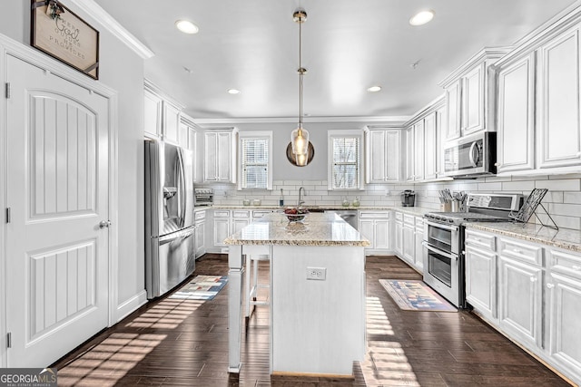 kitchen featuring appliances with stainless steel finishes, dark wood-style flooring, white cabinets, and tasteful backsplash