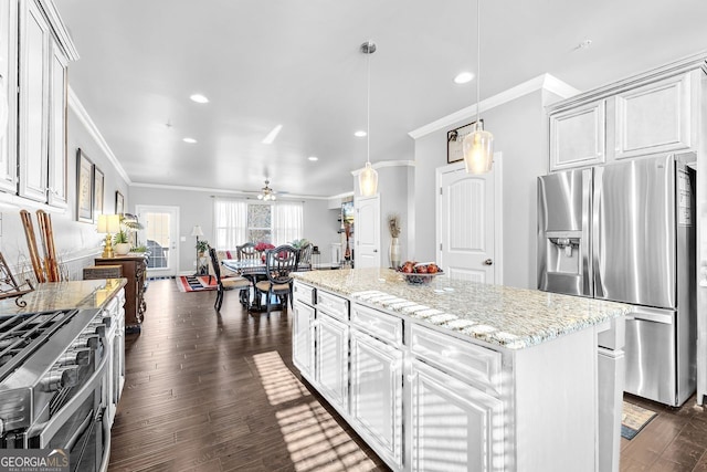 kitchen featuring dark wood-style floors, crown molding, stainless steel appliances, a kitchen island, and light stone countertops