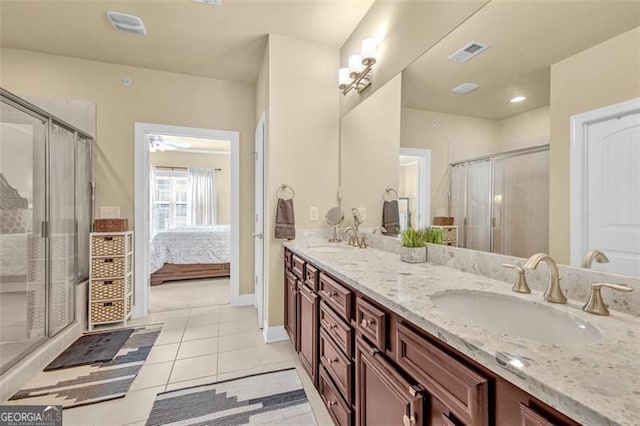 bathroom featuring vanity, tile patterned floors, and a shower with shower door