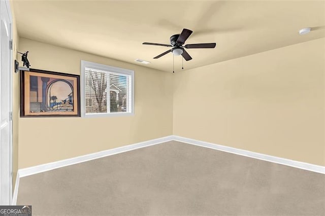 carpeted spare room with ceiling fan