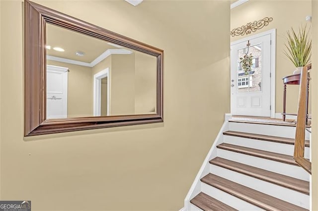 staircase with baseboards and ornamental molding