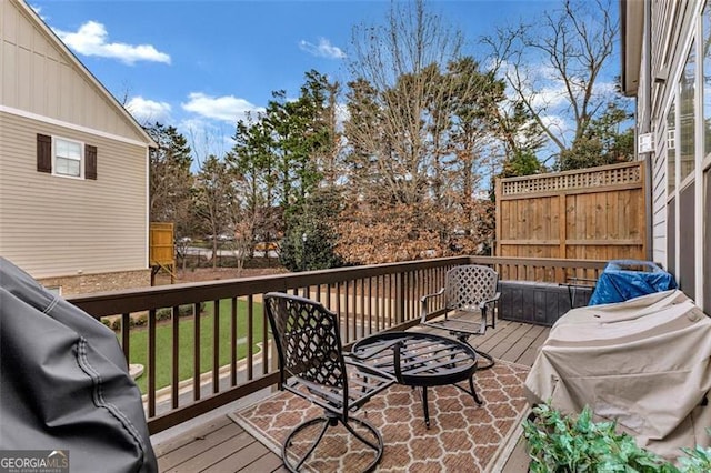 wooden terrace featuring a grill