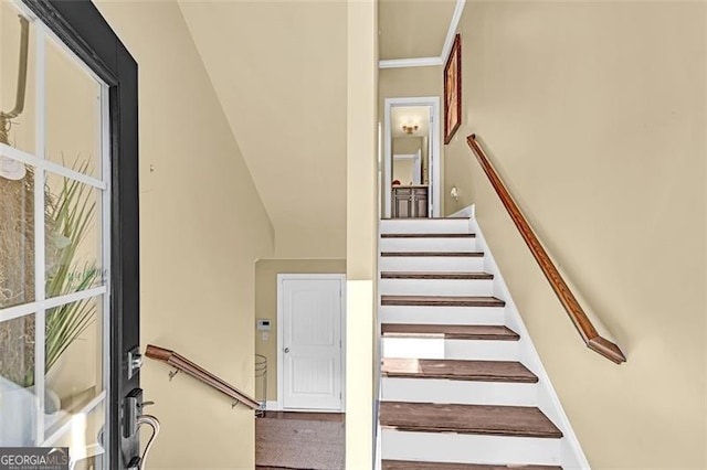 stairway with vaulted ceiling