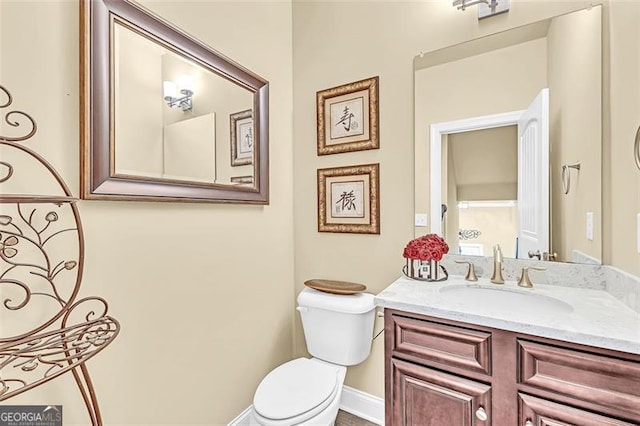 bathroom featuring vanity and toilet