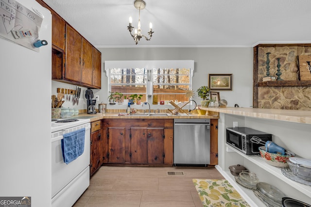 kitchen with pendant lighting, an inviting chandelier, crown molding, sink, and appliances with stainless steel finishes