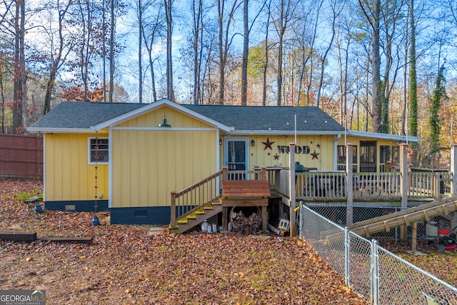 rear view of house with a wooden deck