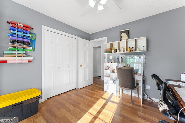 office space featuring ceiling fan, wood-type flooring, and a textured ceiling