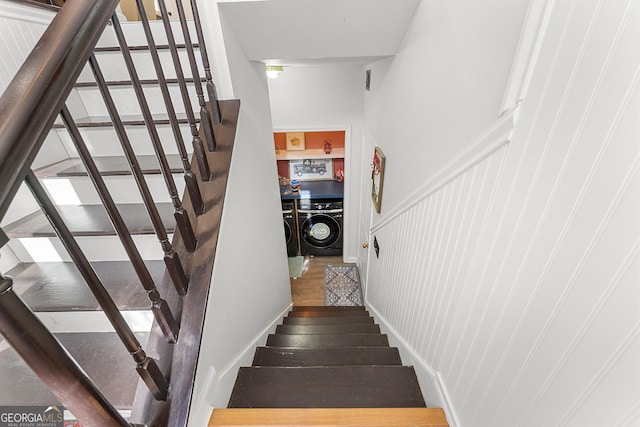 staircase featuring washer and clothes dryer and wood-type flooring