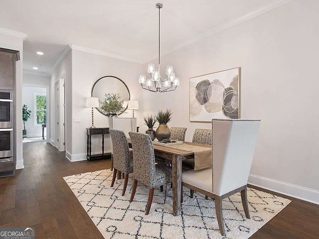 dining room with hardwood / wood-style floors, crown molding, and a chandelier